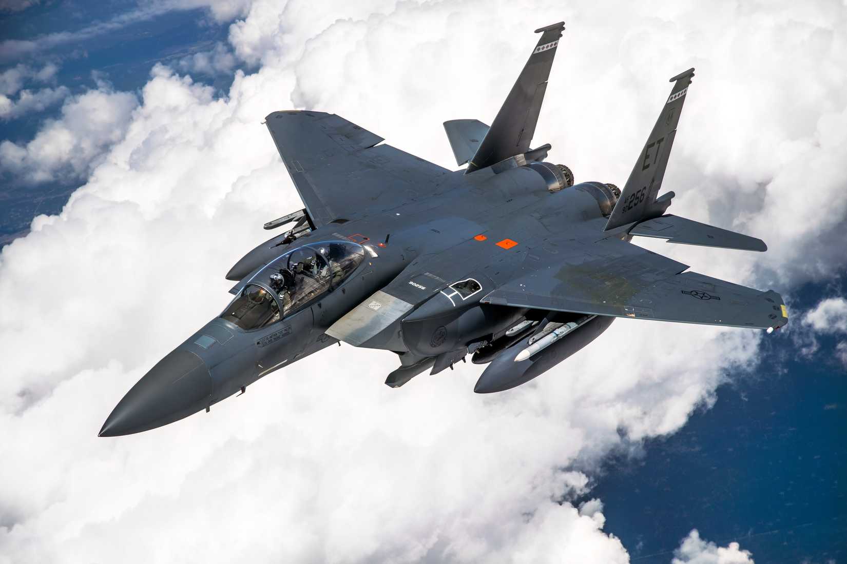 F-15EX flying above the clouds.