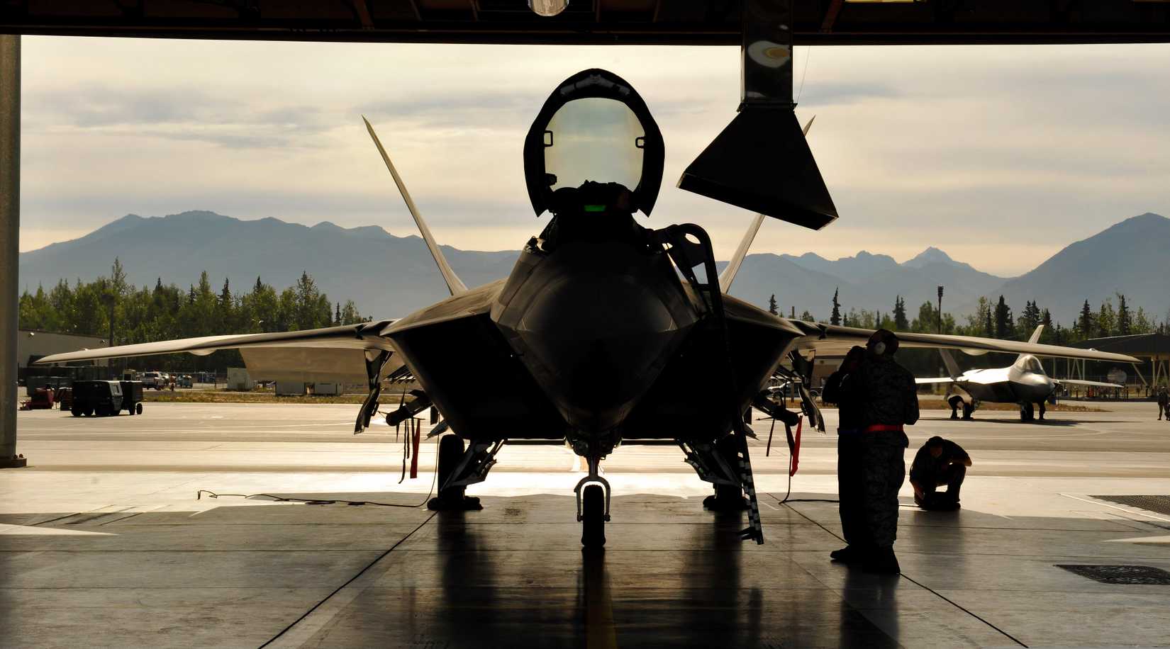 F-22 undergoing maintenance in a hangar 