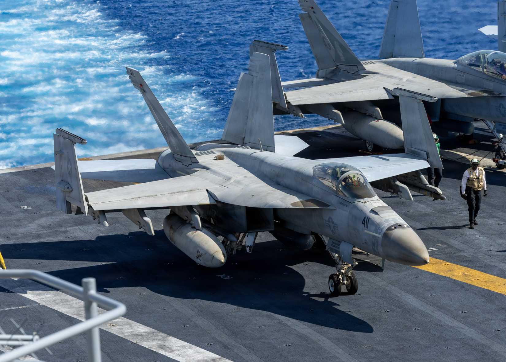 FA-18E Super Hornet taxis the flight deck aboard Nimitz-class aircraft carrier USS George H.W. Bush (CVN 77).
