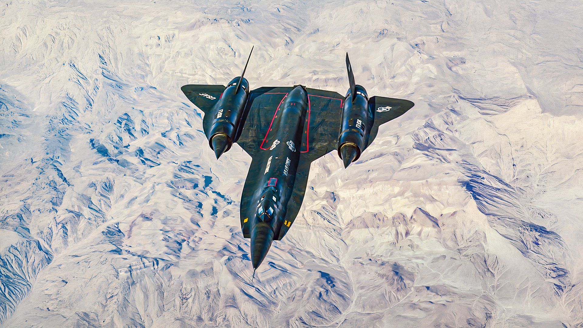Lockheed YF-12 flying over over a mountain range.