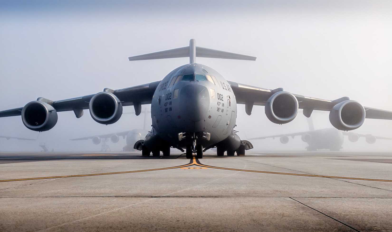 A C-17 is on the apron of an airbase, possibly getting ready for takeoff.