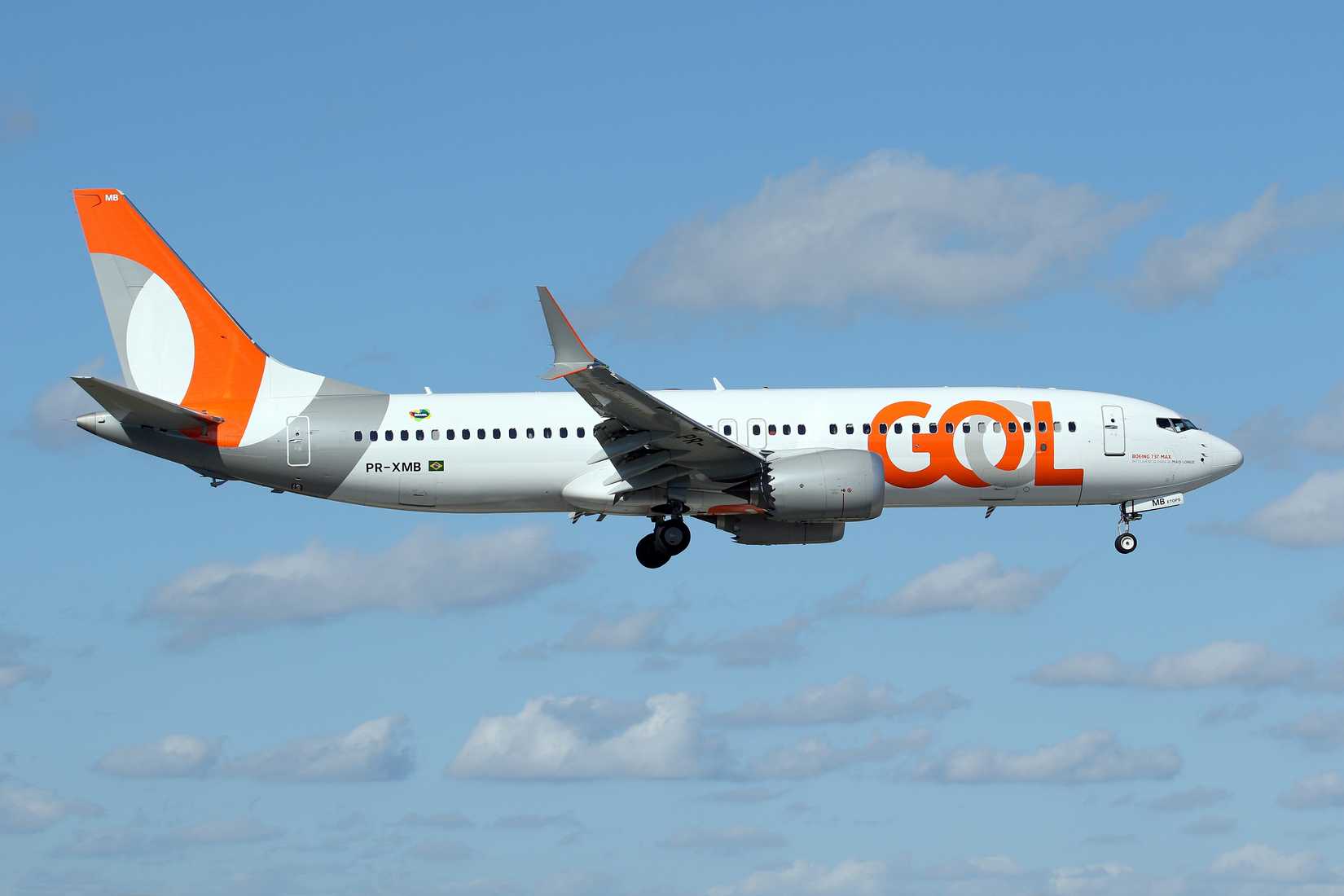 GOL Boeing 737 MAX 8 flying across cloudy skies