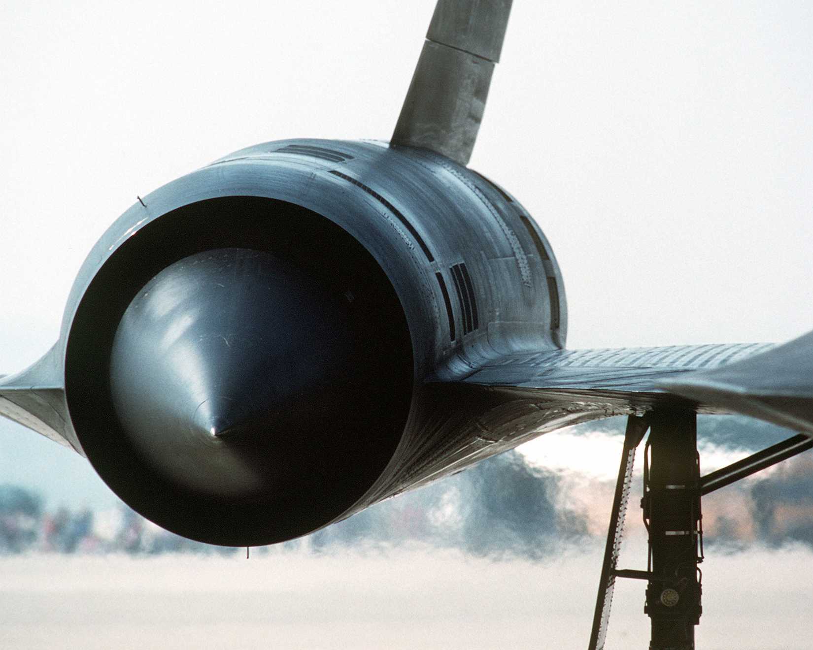 Heat waves radiate from an engine as a 9th Strategic Reconnaissance Wing SR-71 aircraft taxis on the flight line.
