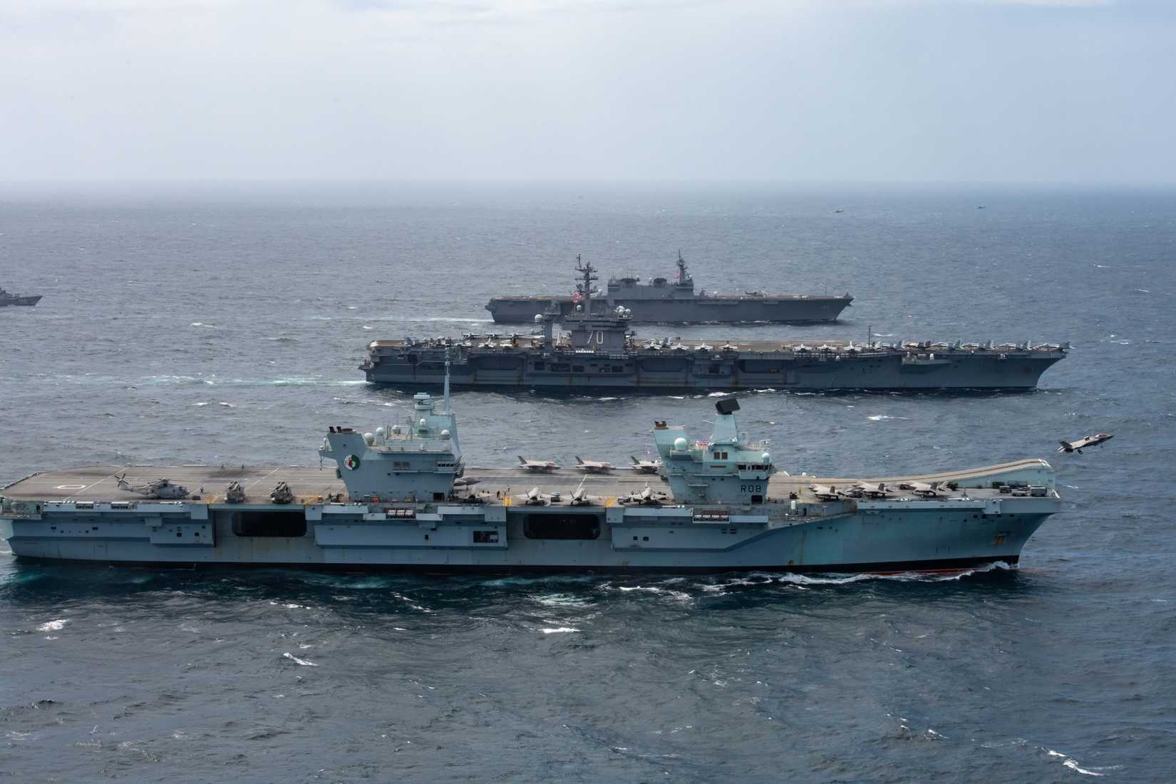 HMS Queen Elizabeth (R 08),  steams alongside  USS Carl Vinson (CVN 70), and Japan Maritime Self- Defense Force JS Kaga (DDH 184).