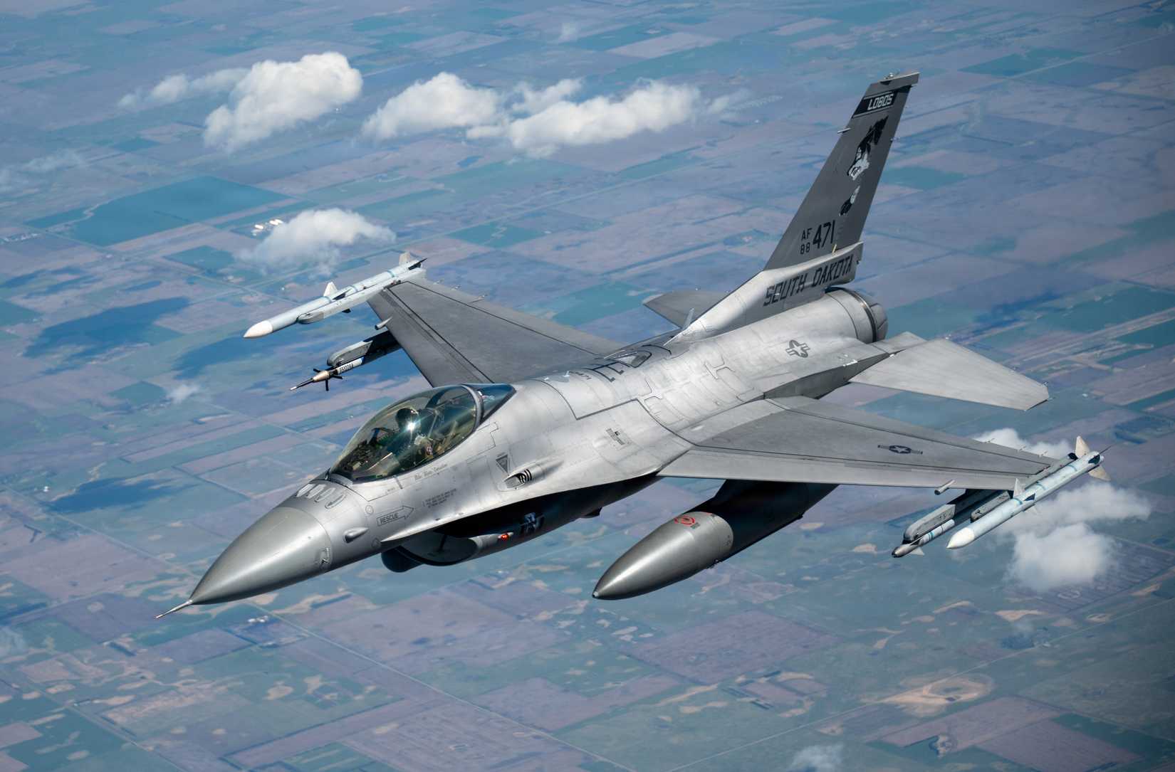 Iowa Air National Guard Airmen assigned to the 185th Air Refueling Wing refuel F-16 Fighting Falcons from the 114th Fighter Wing using a KC-135 Stratotanker during a training mission.