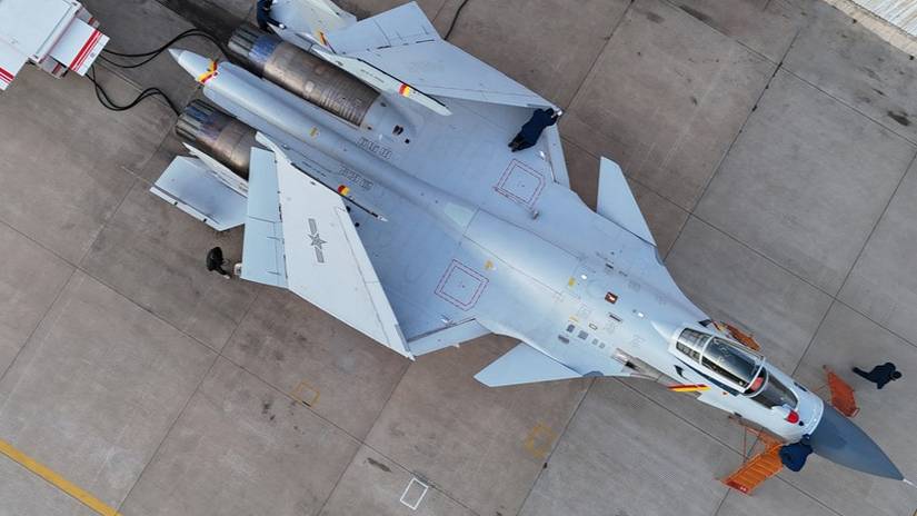 Maintenance men assigned to a training base of the Chinese PLA Naval Aviation University conduct pre-flight inspection during a multi-subject flight training exercise in early December, 2025.
