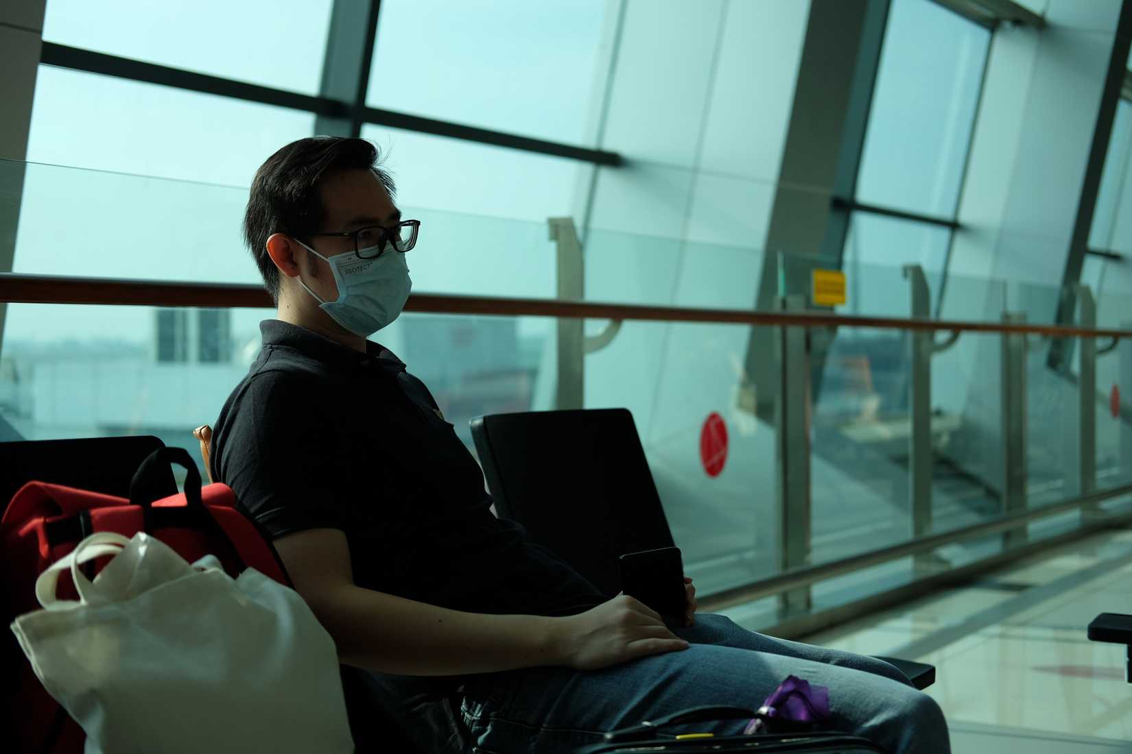 man at gate wearing a mask during pandemic