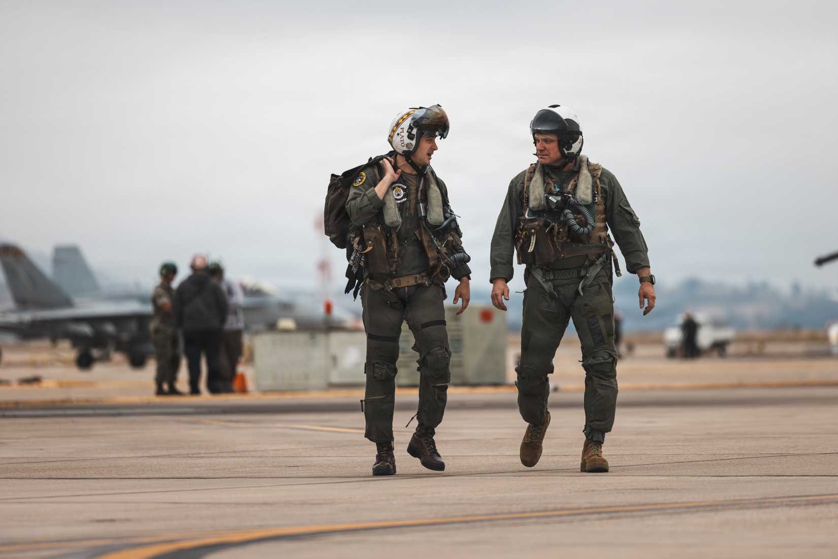 Marine Corps Brig. Gen. Michael R. Nakonieczny, and Maj. Ryan P. Clark, an FA-18D Hornet pilot walk off the flightline on Marine Corps Air Station Miramar.