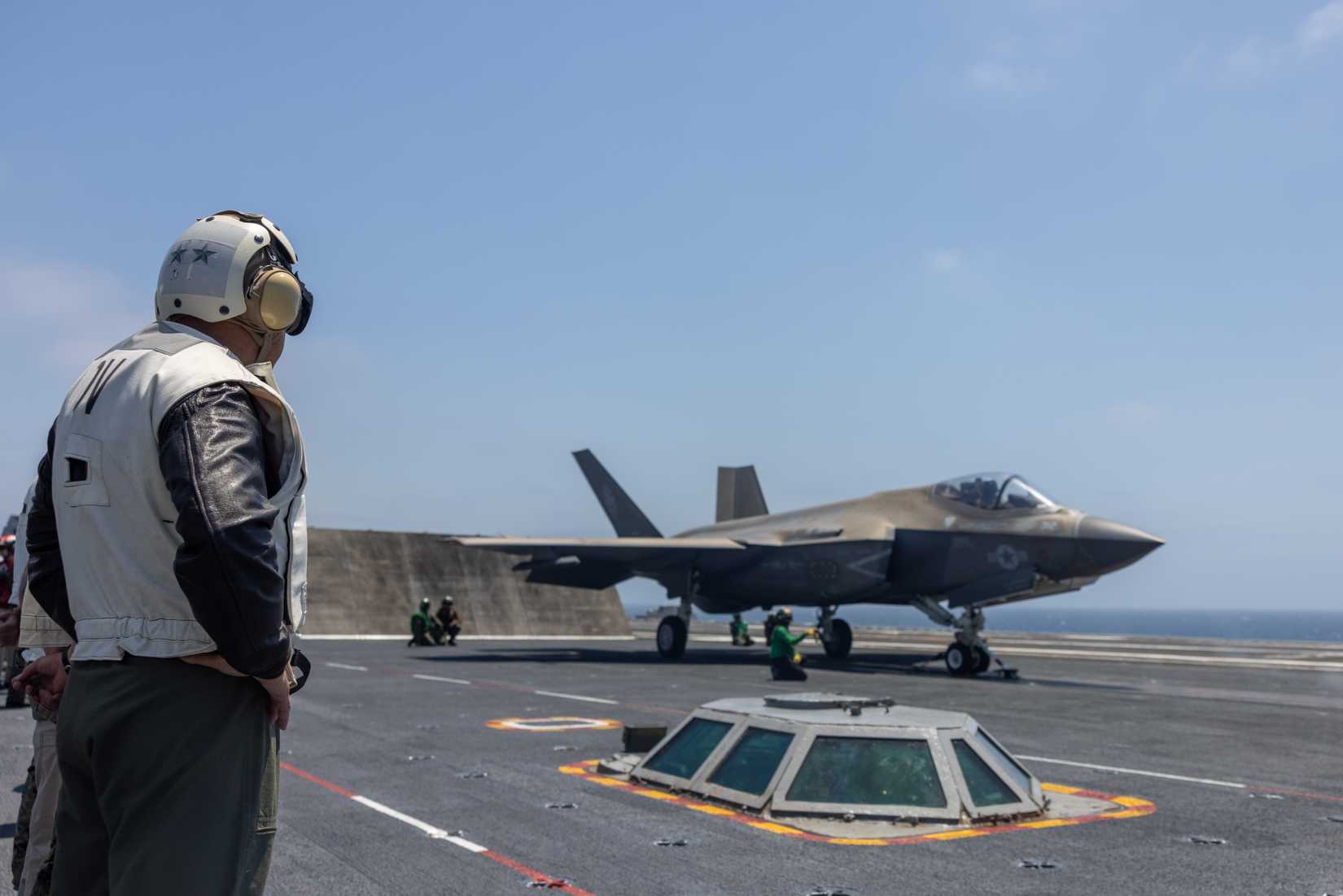 Marine Corps Maj. Gen. James B. Wellons, the commanding general of 3rd Marine Aircraft Wing, observes an F-35C Lightning II prepare for a catapult launch, or cat shot.