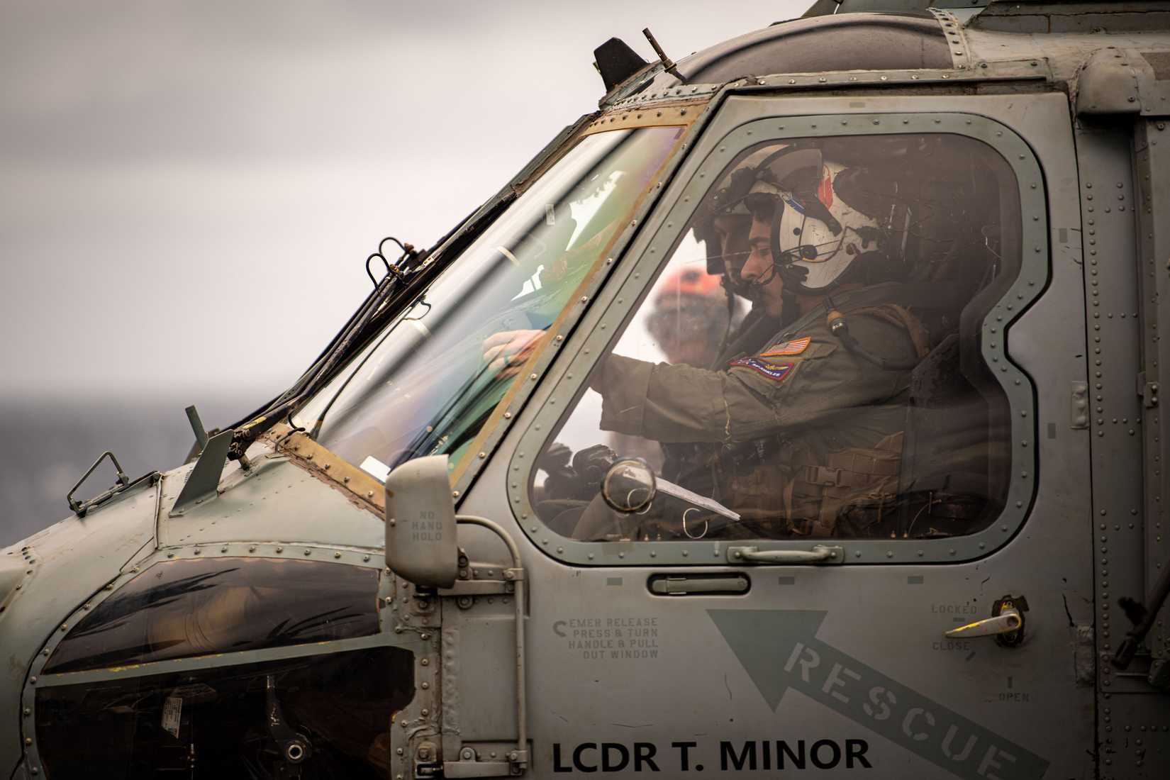 Navy pilots prepare to fly an MH-60S Sea Hawk, attached to the “Indians” of Helicopter Sea Combat Squadron (HSC) 6, from the flight deck.