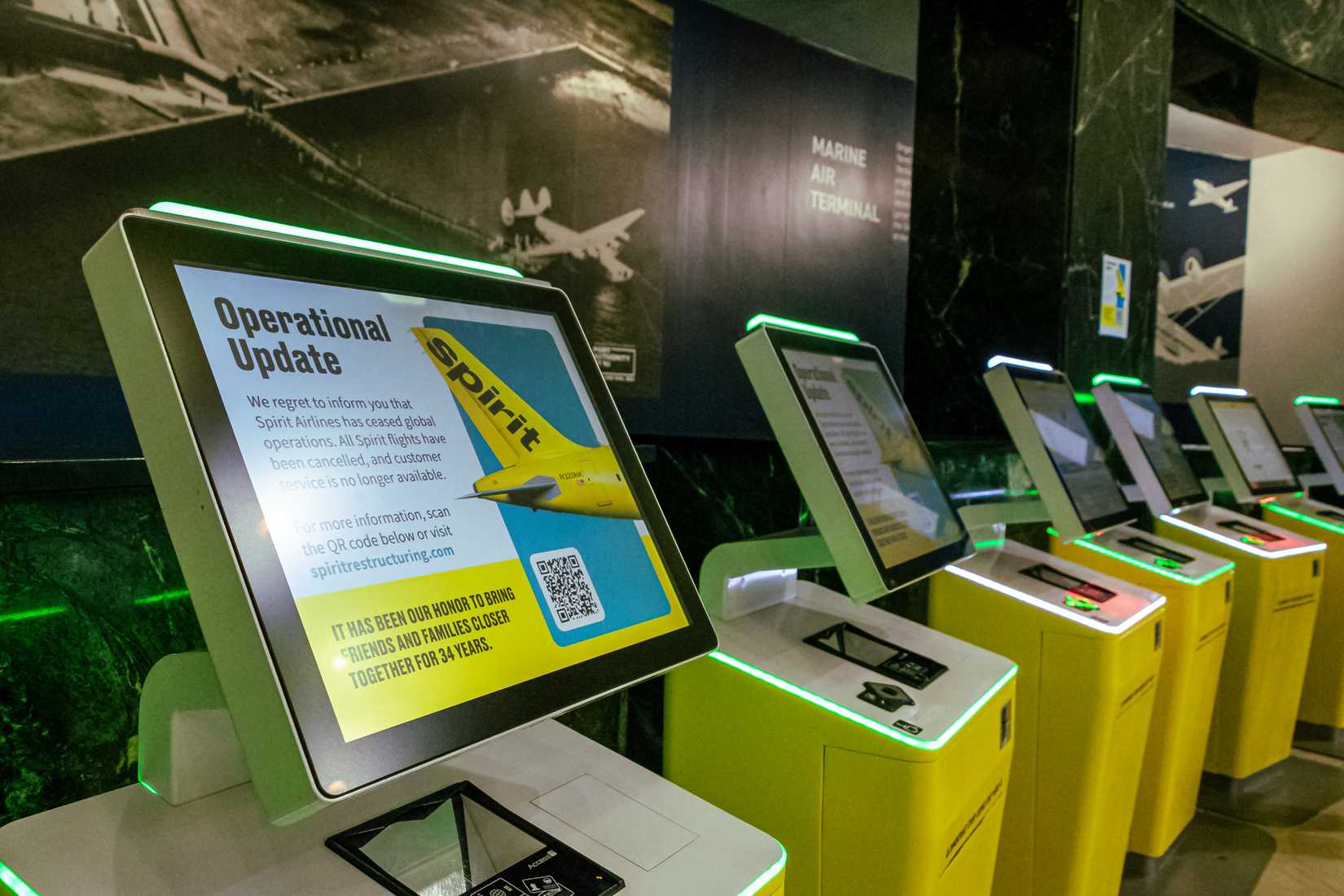 Several Spirit Airlines Self-Service Kiosks at Terminal A inside NYC's LaGuardia Airport.