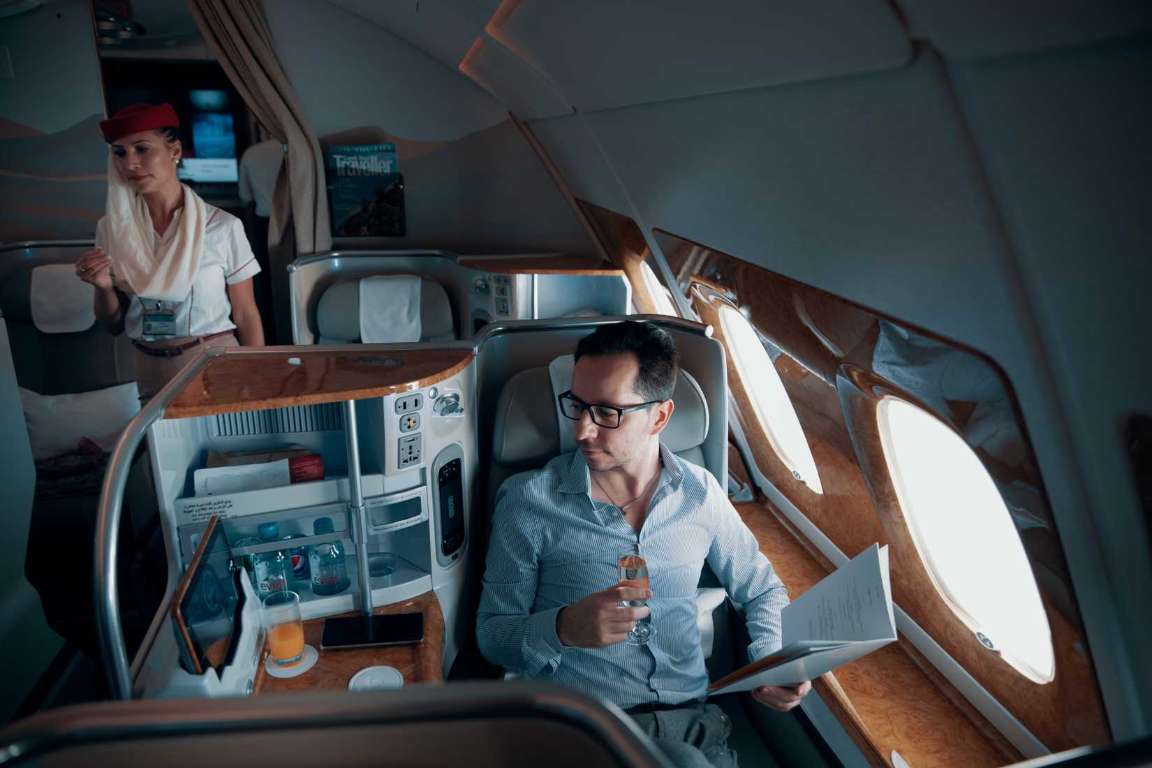 male seated in business class Emirates