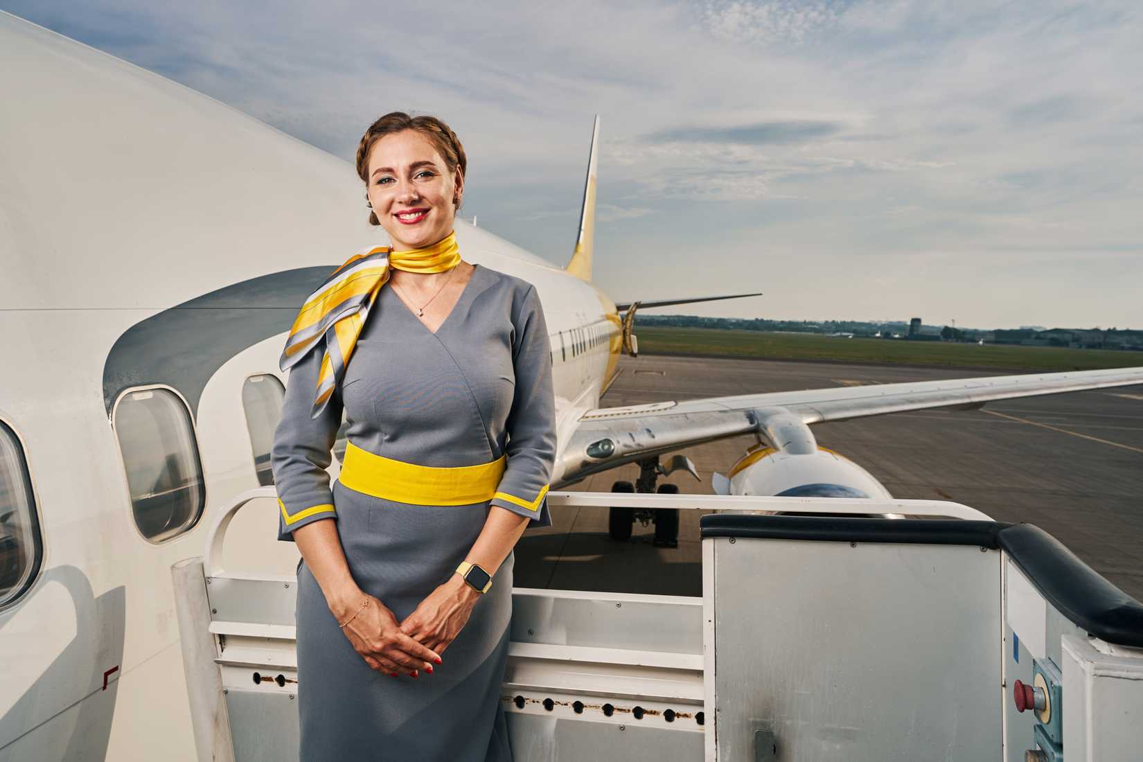 flight attendant on steps outside aircraft