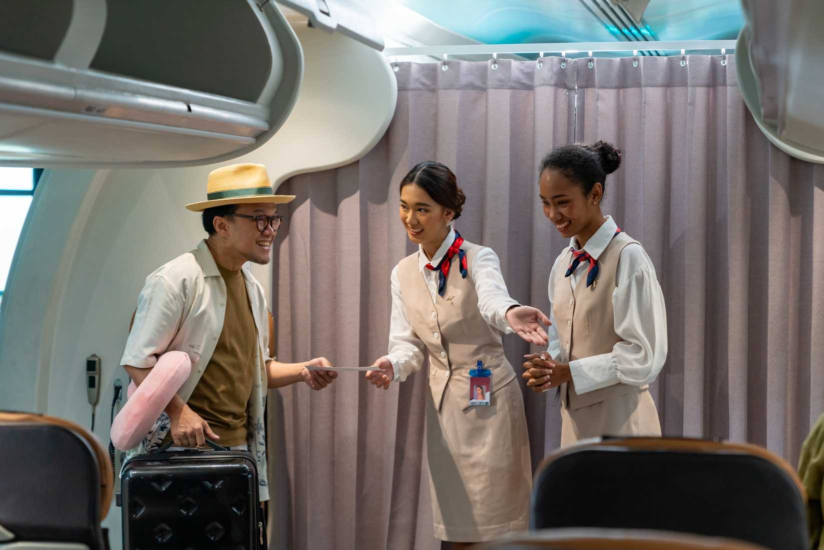 Flight attendants greeting the passenger and welcoming them on the aircraft 