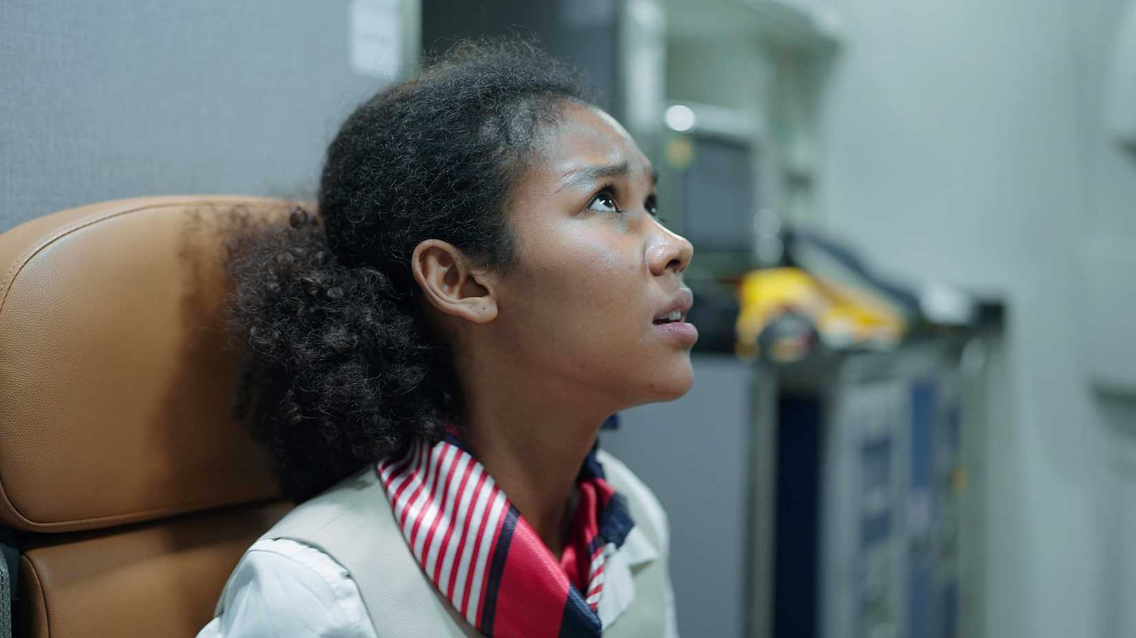 stressed flight attendant at seat