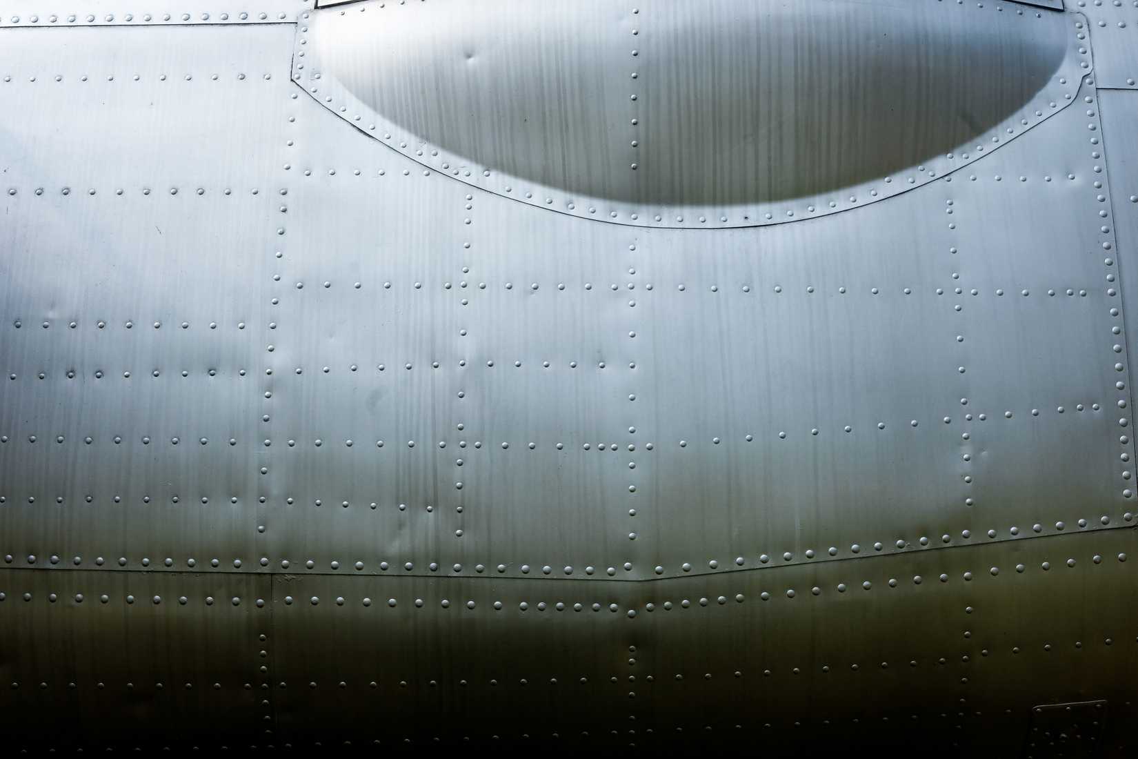 Aluminum surface of vintage aircraft fuselage body