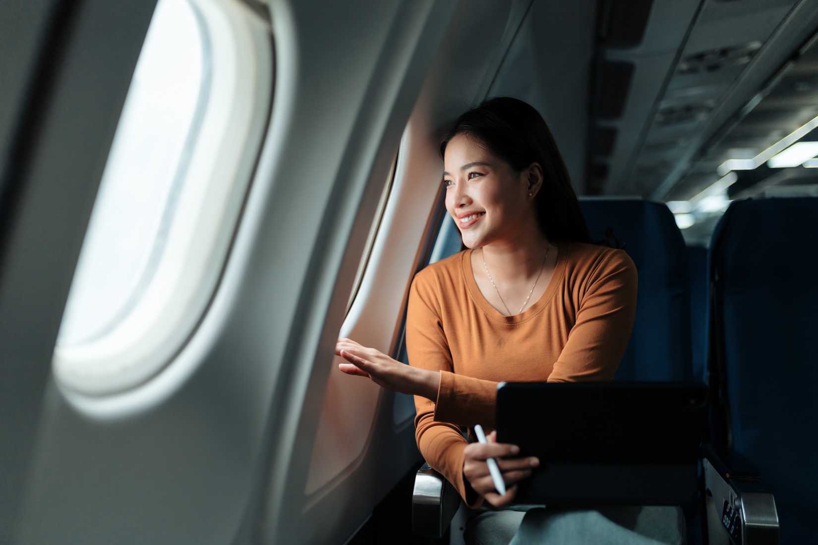 female passenger looking out of window smiling
