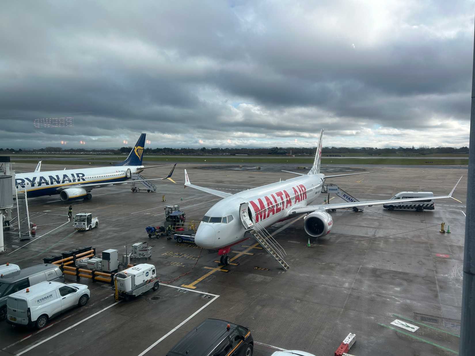 Malta Air Boeing 737 with a Ryanair plane in the background, on the apron in front of at Terminal 3. Manchester, UK.
