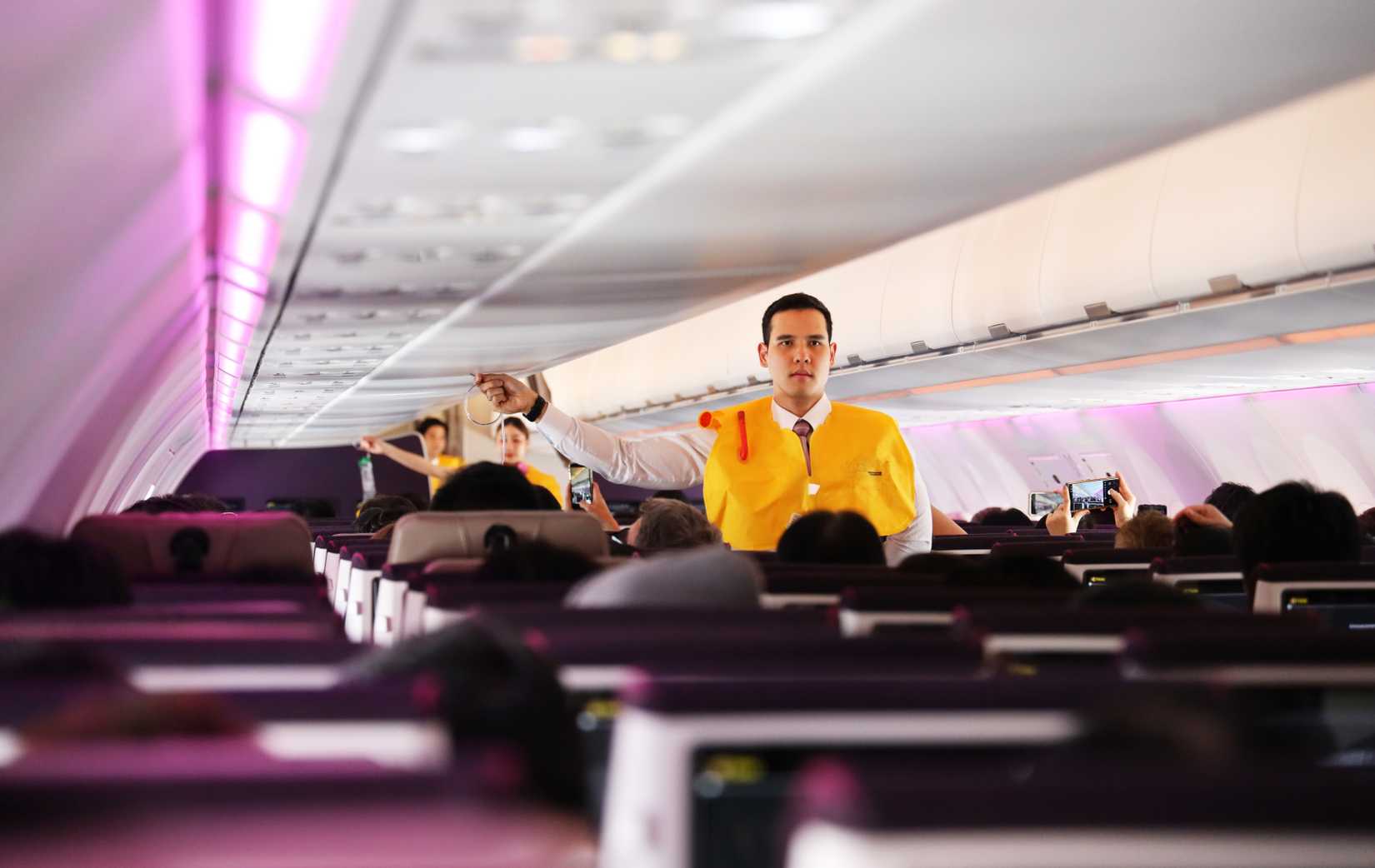 male flight attendant safety demonstration