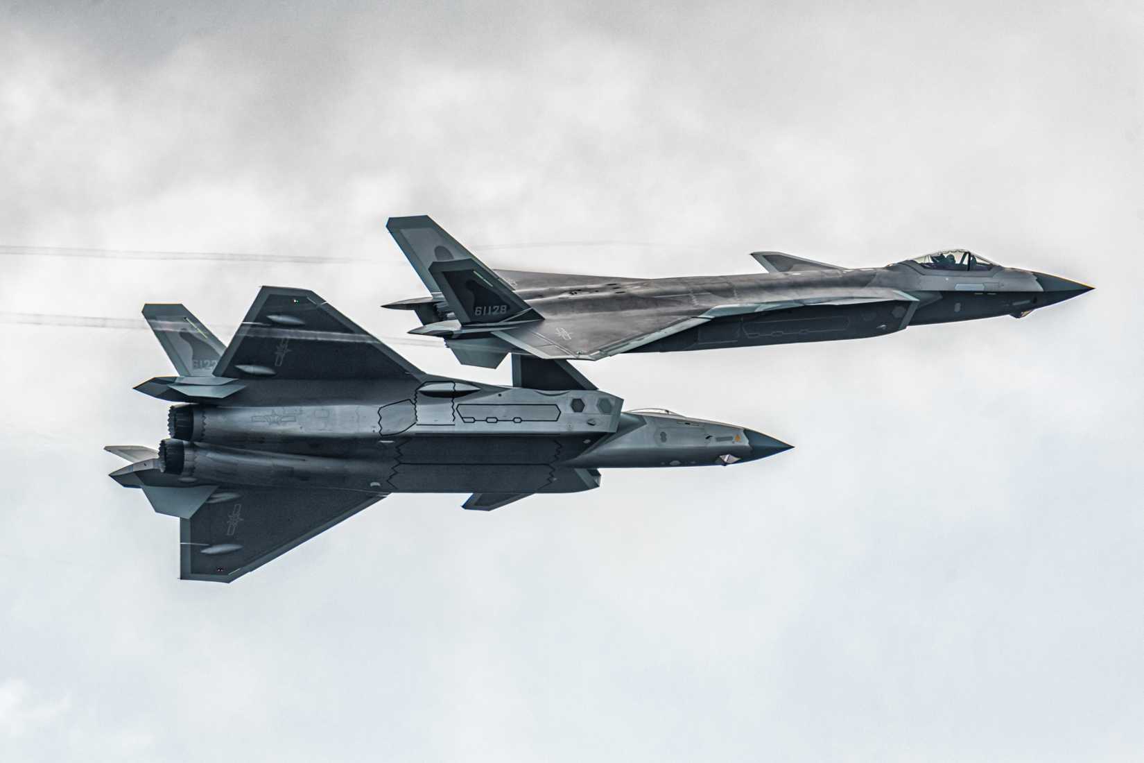 Zhuhai Airshow, China, Chengdu J-20 stealth fighter jet soaring high in the sky, demonstrating China’s advanced fifth-generation combat aircraft power.