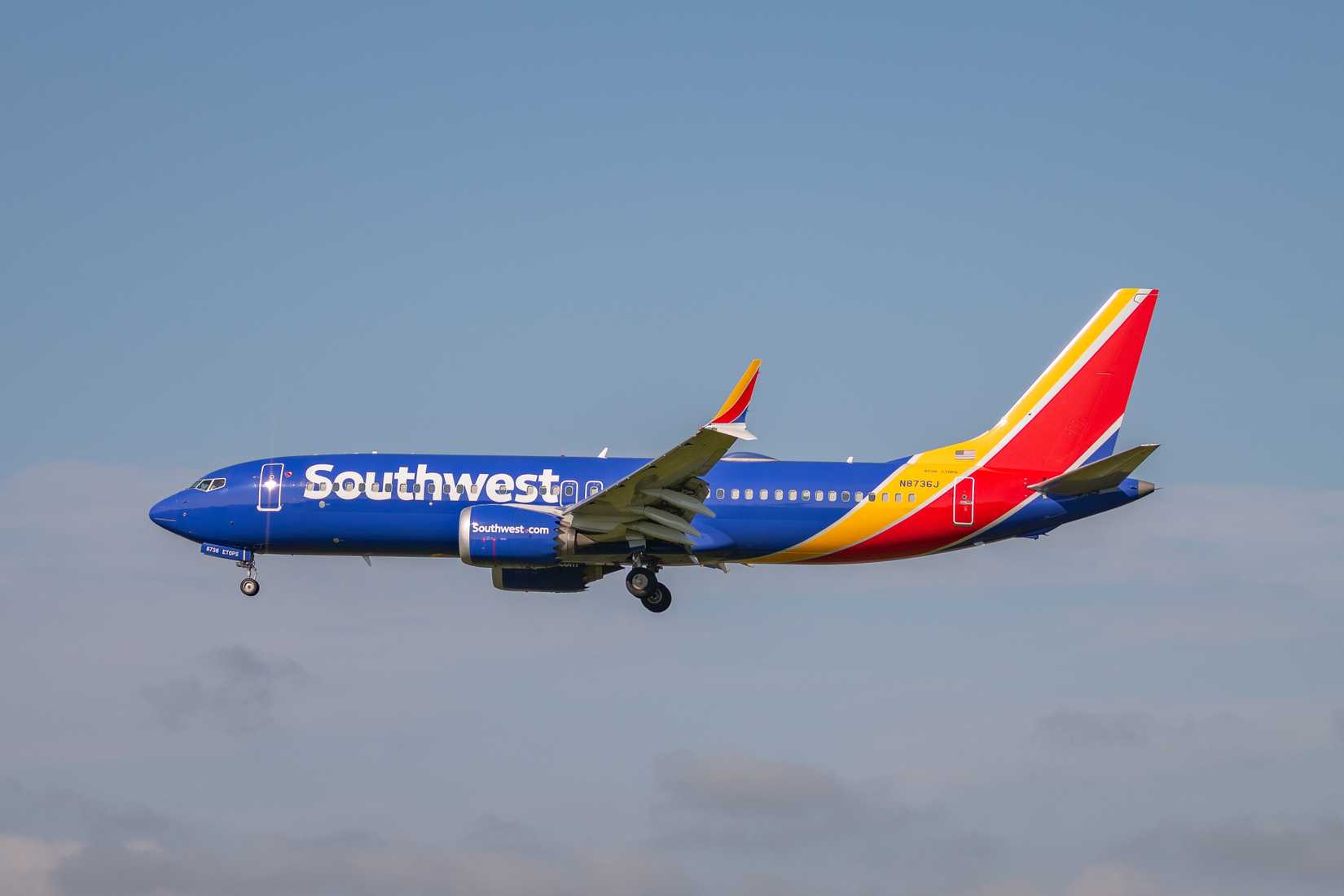 Southwest 737 MAX 8 flying across grey sky