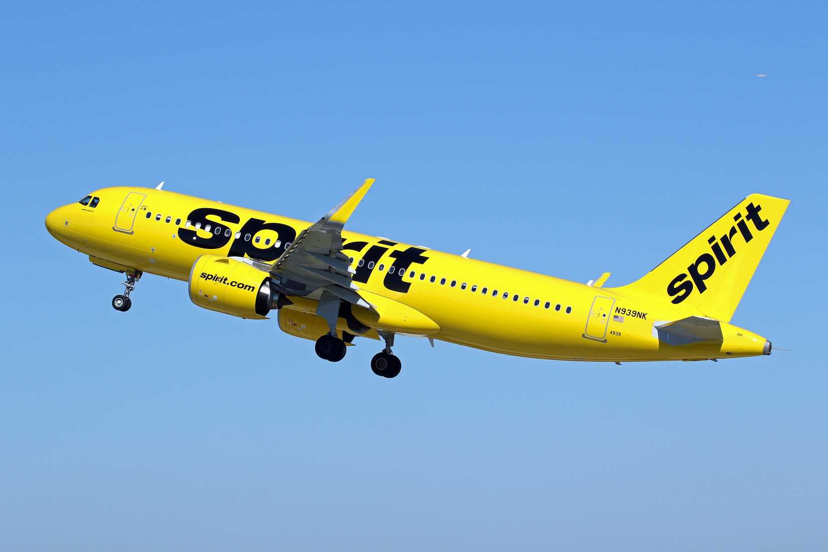 Spirit Airlines A320neo flying across clear skies