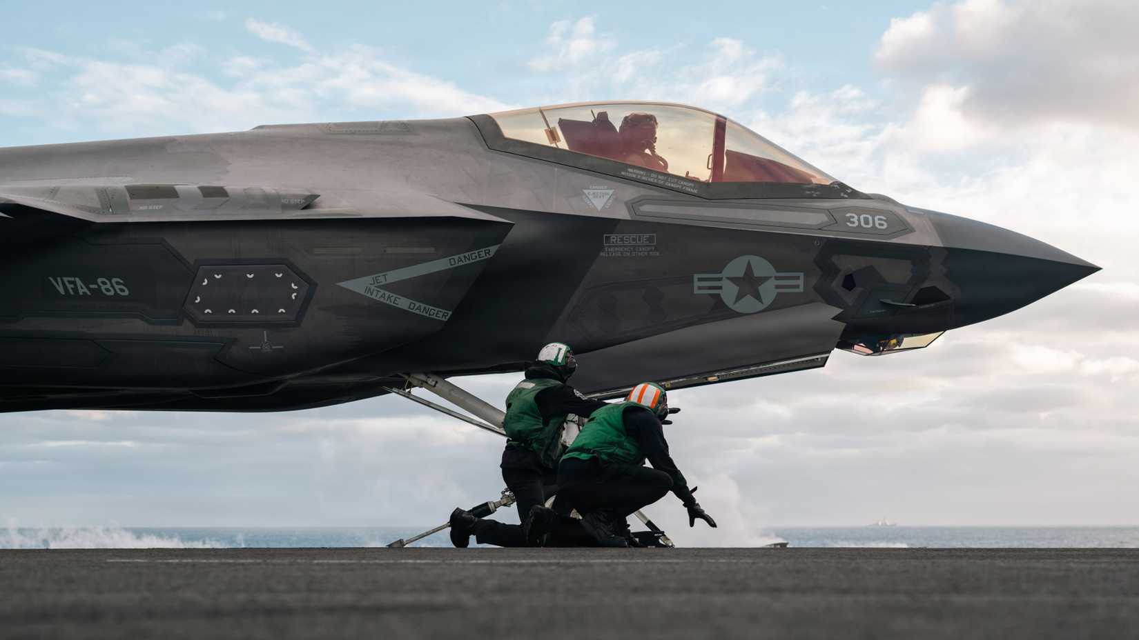 U.S. Sailors, assigned to the Nimitz-class aircraft carrier USS Theodore Roosevelt (CVN 71), conduct pre-launch checks on an F-35C Lightning II.