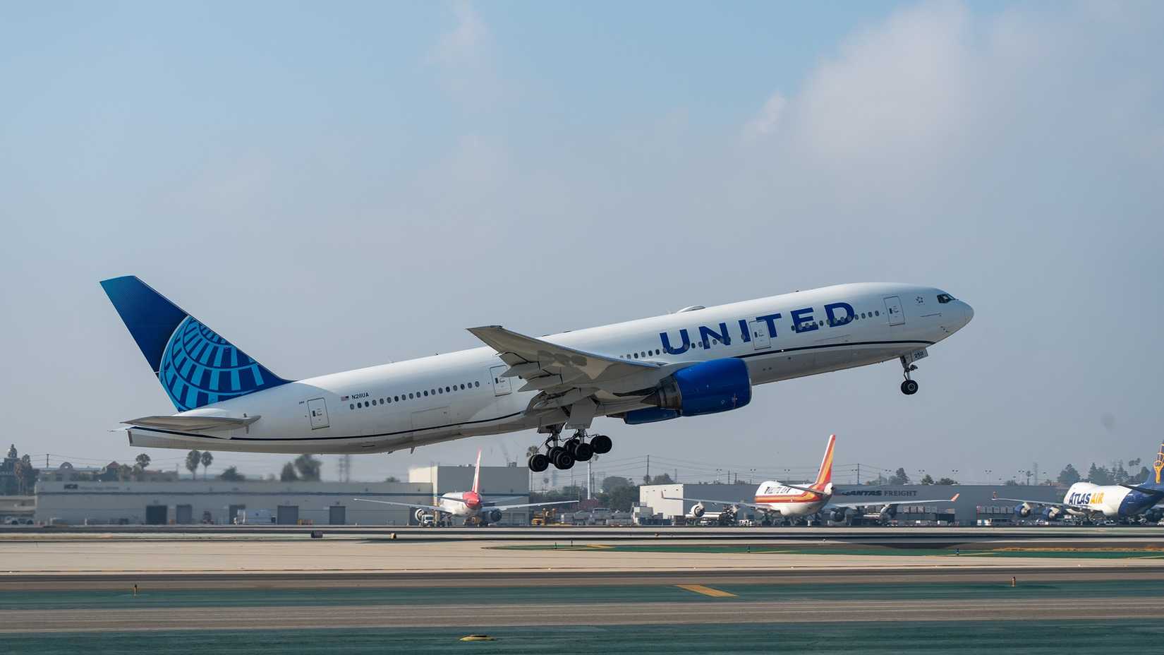 United Airlines Boeing 777 taking off from LAX Airport on a clear morning