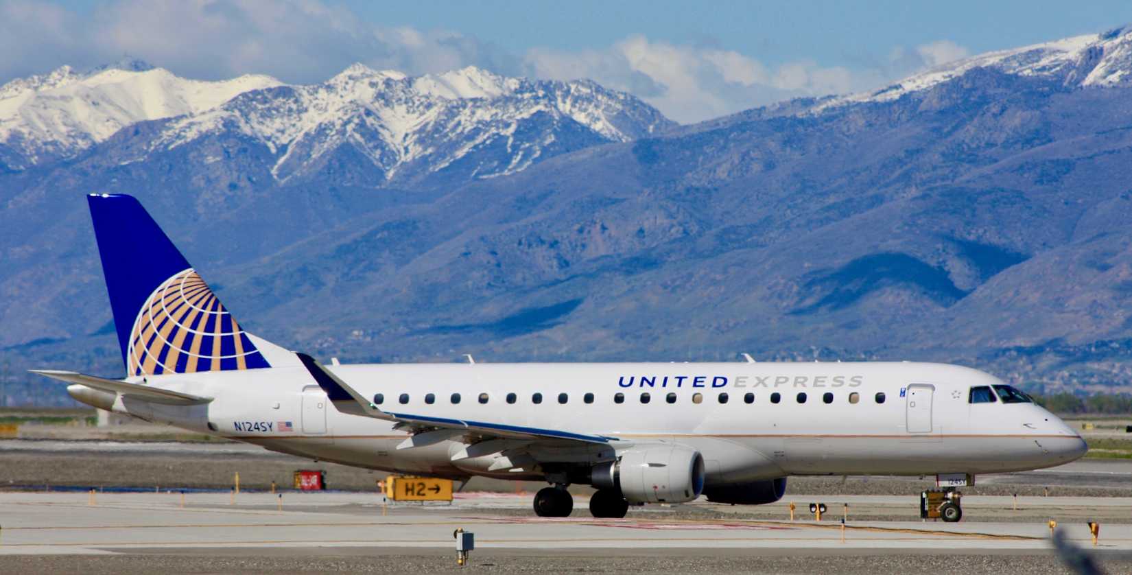 United Express E175 on apron mountain background