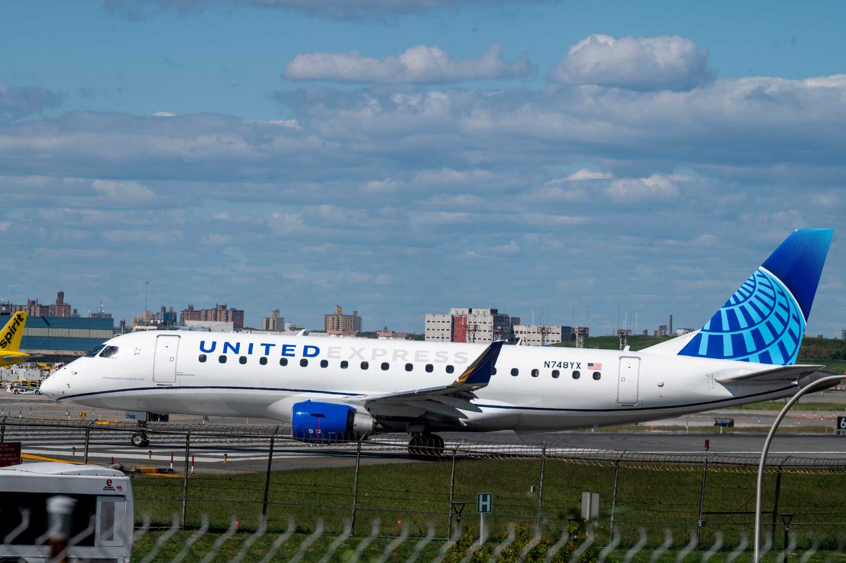United Express Embraer ERJ-170-200 LR tail number N748YX airplane taxiing to the runway for takeoff at LaGuardia Airport.