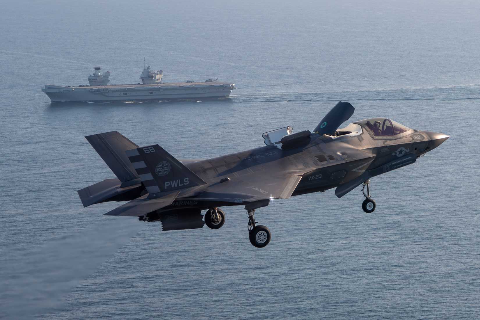 USMC VX-23 ferries an F-35B Lightning II fighter aircraft to the U.K. HMS Prince of Wales aircraft carrier in the Western Atlantic Oct. 11, 2023.