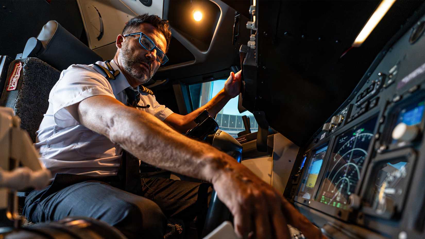 A pilot at his aircraft's controls