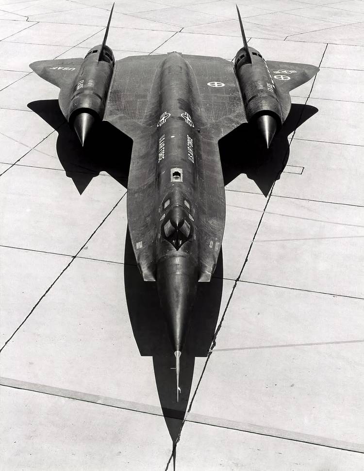 Black and white photo of a YF-12 sitting on the apron of an airbase. 