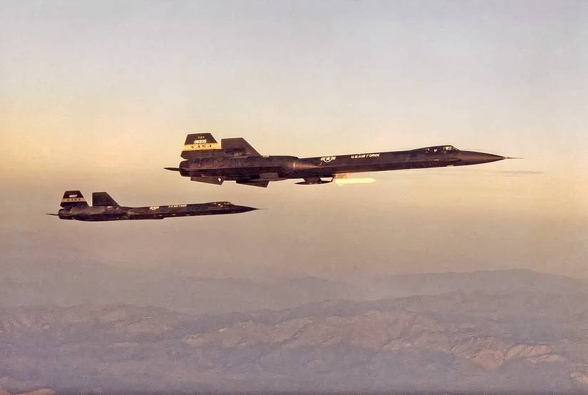 Two YF-12's flying together with the sunset as a backdrop. 