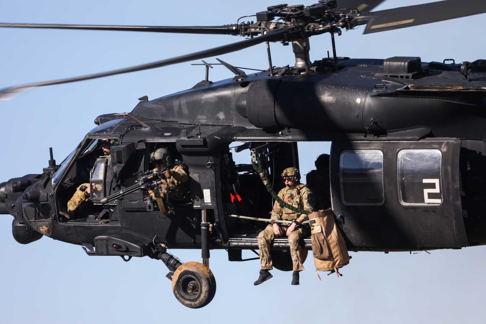 160th Special Operations Aviation Regiment (SOAR), fires an M2 machine gun from a UH-60 Black Hawk helicopter in a training exercise with Green Berets 