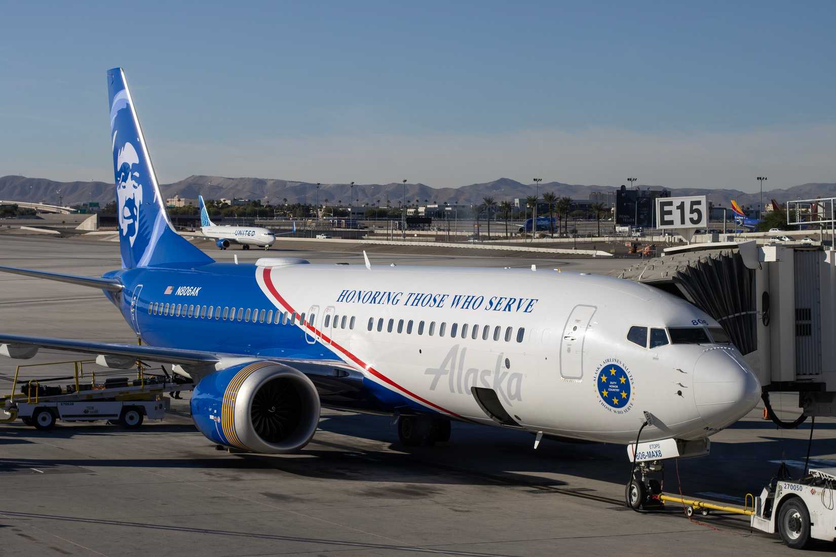 A Boeing 737-8 MAX aircraft operated by Alaska Airlines, featuring a special Honoring Those Who Serve livery.