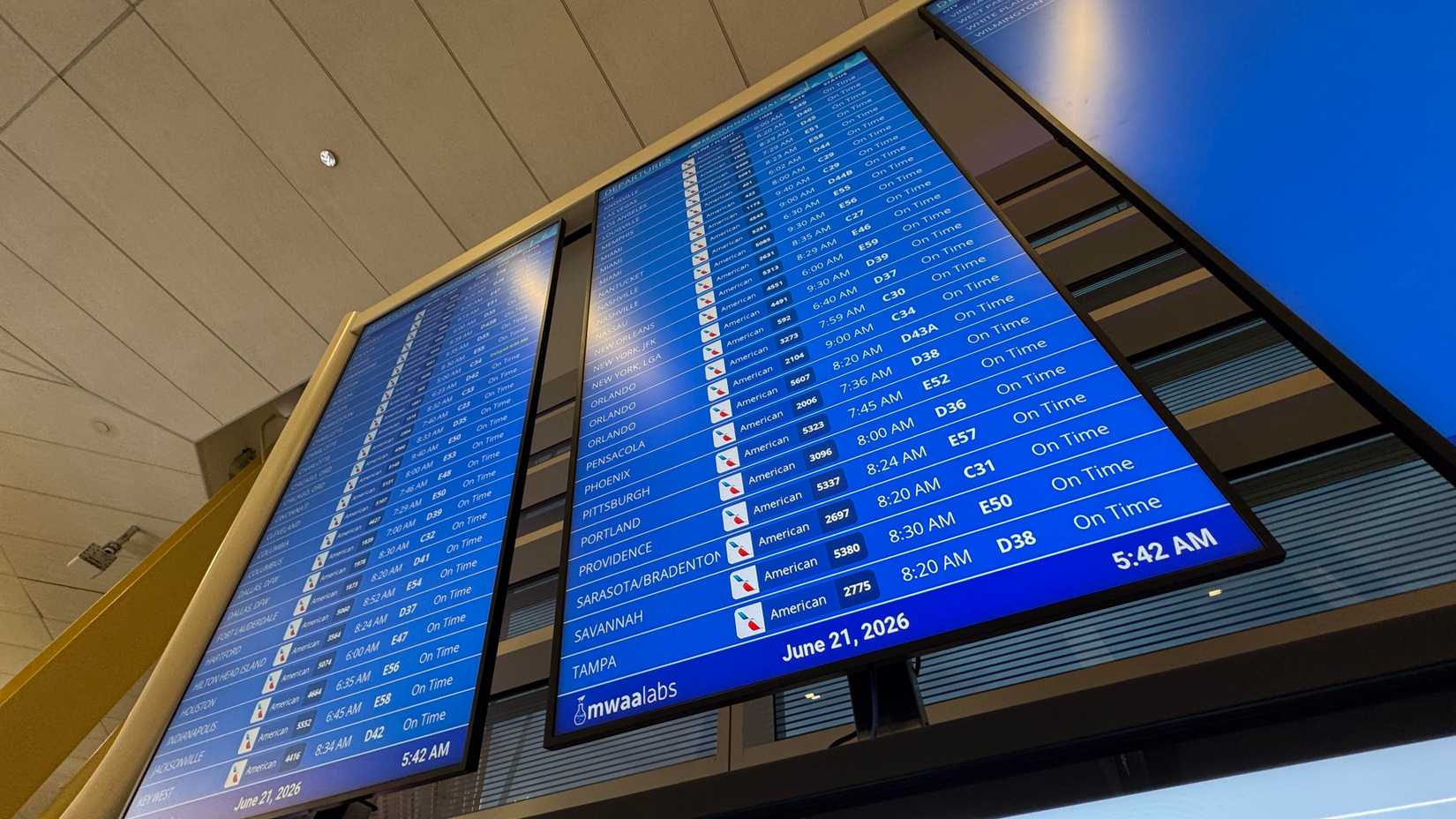 A detailed view of a blue flight information display system (FIDS) at Ronald Reagan Washington National Airport (DCA)%0A