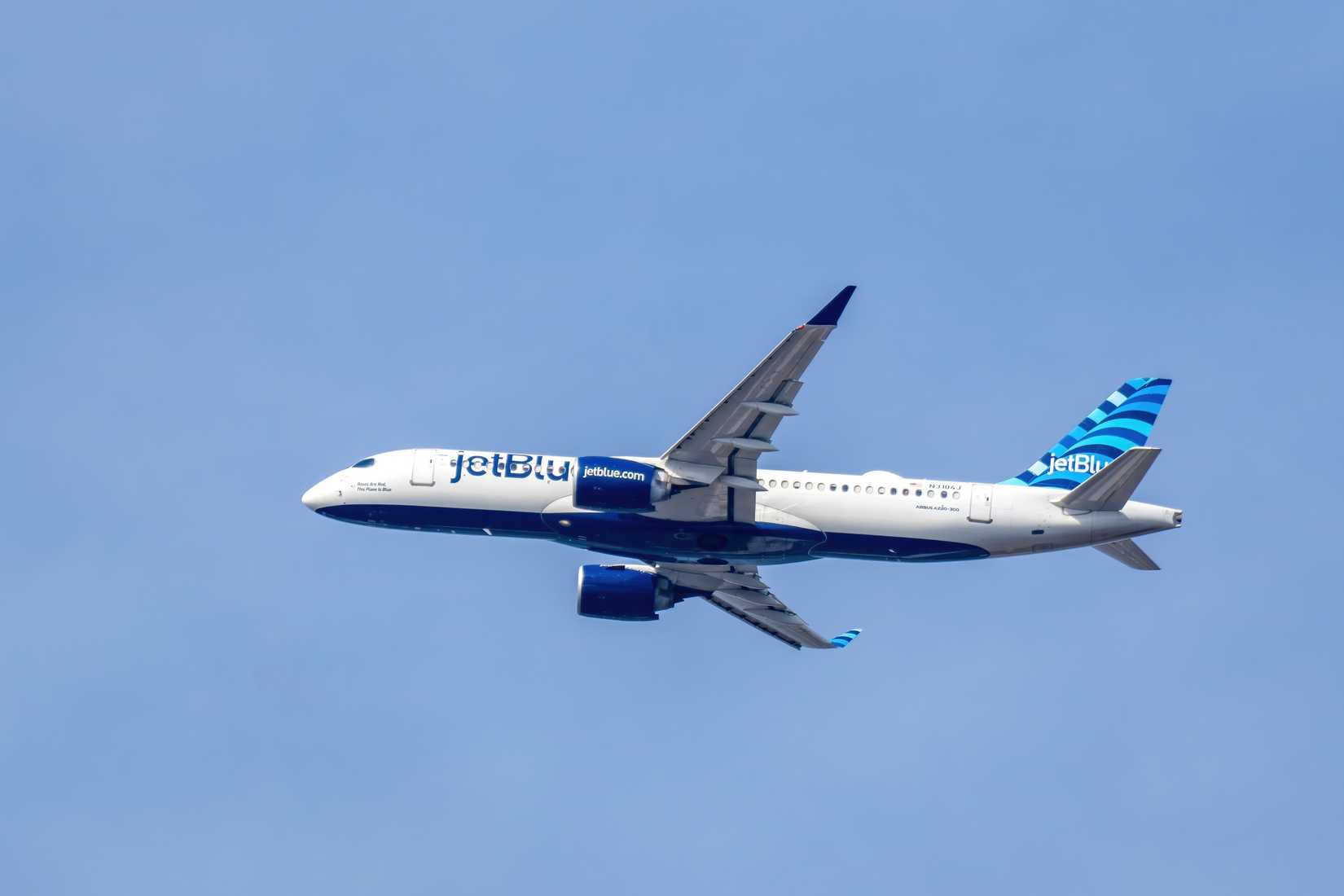 A JetBlue Airways Airbus A320 passenger aircraft flies near Raleigh-Durham International Airport.