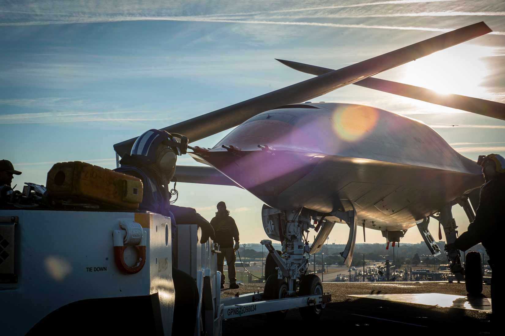 A Sailor repositions a Boeing unmanned MQ-25 aircraft on the flight deck aboard the aircraft carrier USS George H.W. Bush.