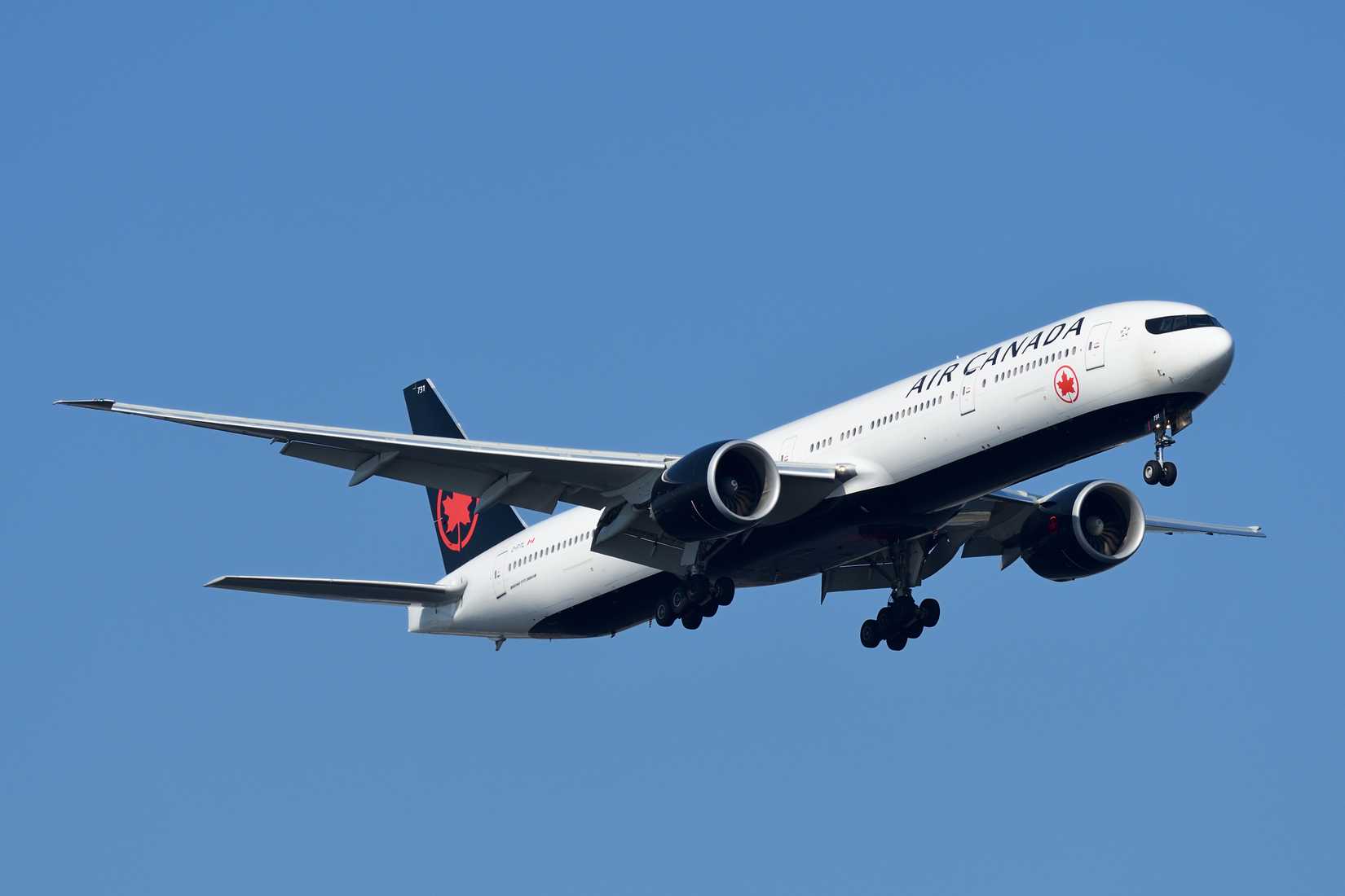 Air Canada Boeing 777 flying across clear skies