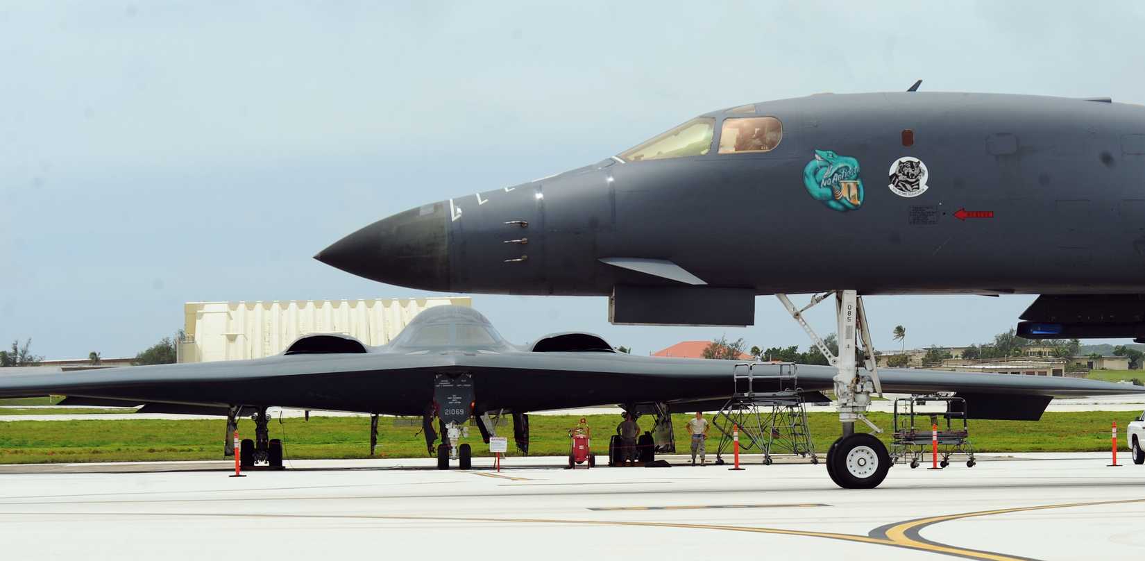 Air Force B-1 Lancer deployed from Ellsworth Air Force Base, S.D., taxis in front of a B-2 Spirit, deployed from Whiteman Air Force Base, Mo., at Andersen Air Force Base, Guam.