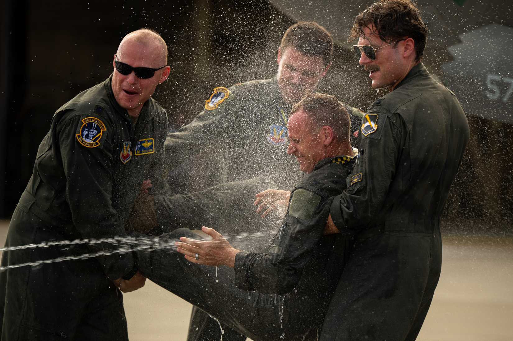 Air Force Col. Christian Bergtholdt, 325th Fighter Wing commander, is sprayed with water following his fini flight at Tyndall Air Force Base, Florida, June 22, 2026