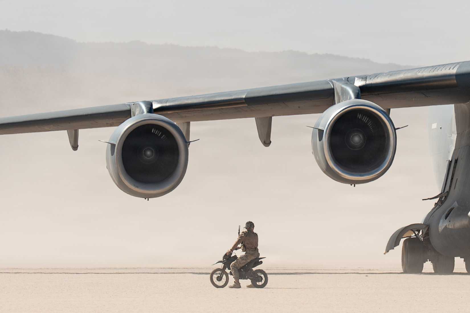 Air Force combat controller assigned to the 66th Weapons Squadron, U.S. Air Force Weapons School, marshals a C-17 Globemaster III at Delamar Dry Lake