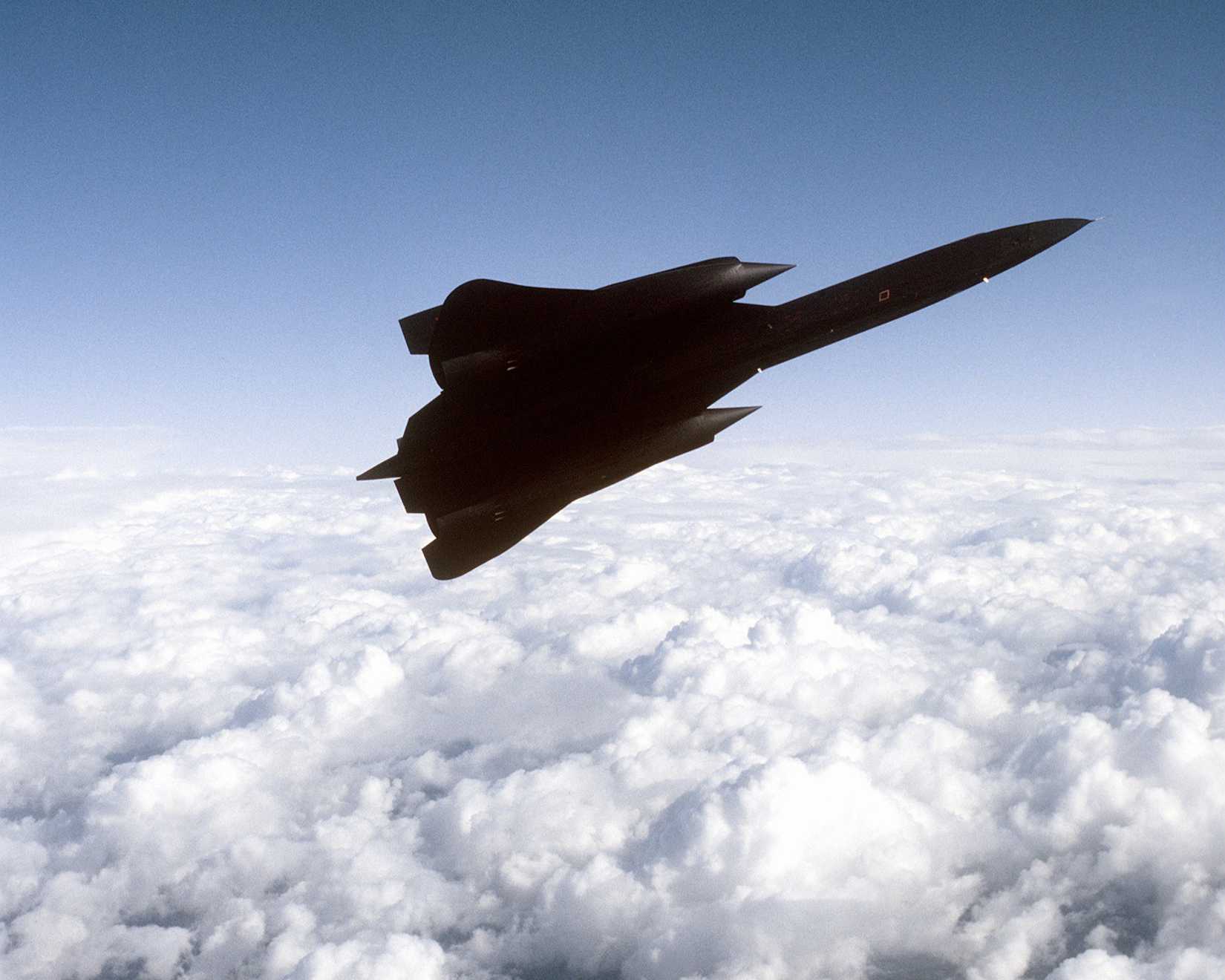 Air to air view right side view of a 9th Strategic Reconnaissance Wing's SR-71 Blackbird reconnaissance aircraft, as it banks left.