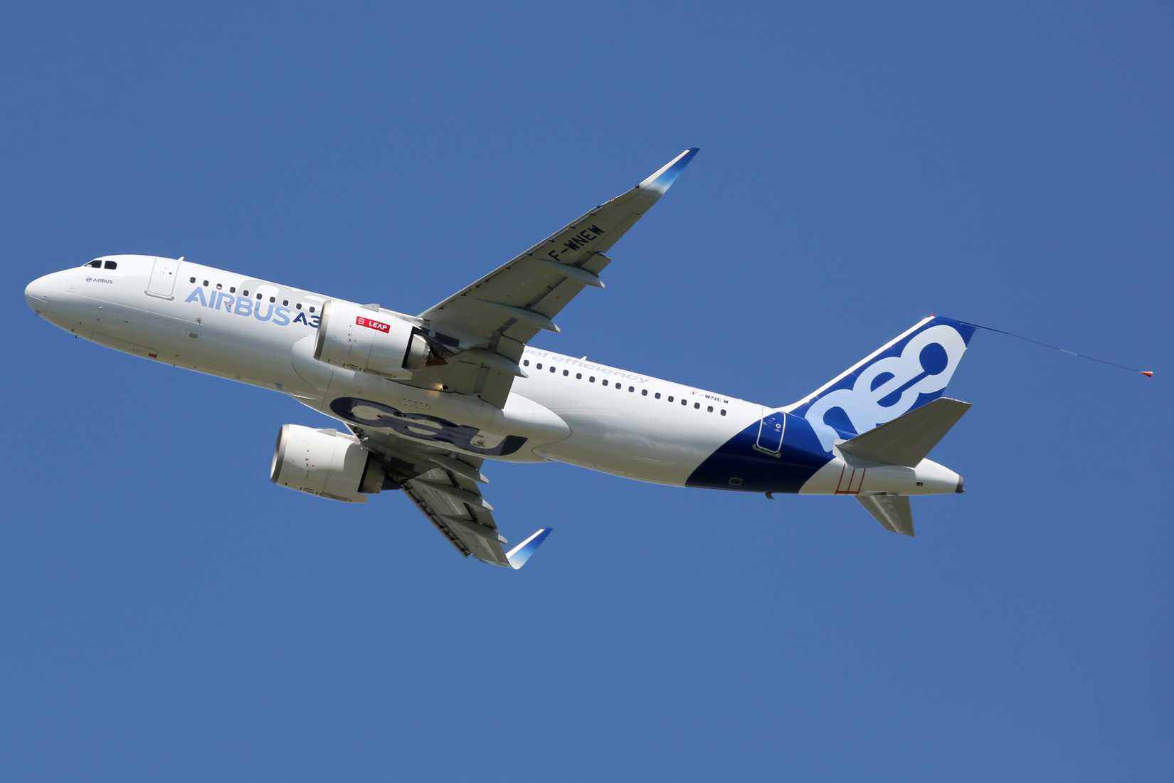 Airbus A320neo flying across clear skies