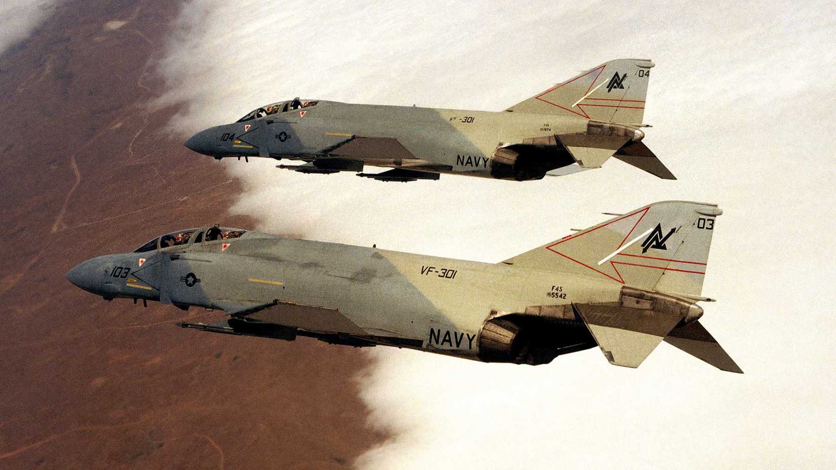 An air-to-air left side view of two Fighter Squadron 301 (VF-301) F-4 Phantom II aircraft.