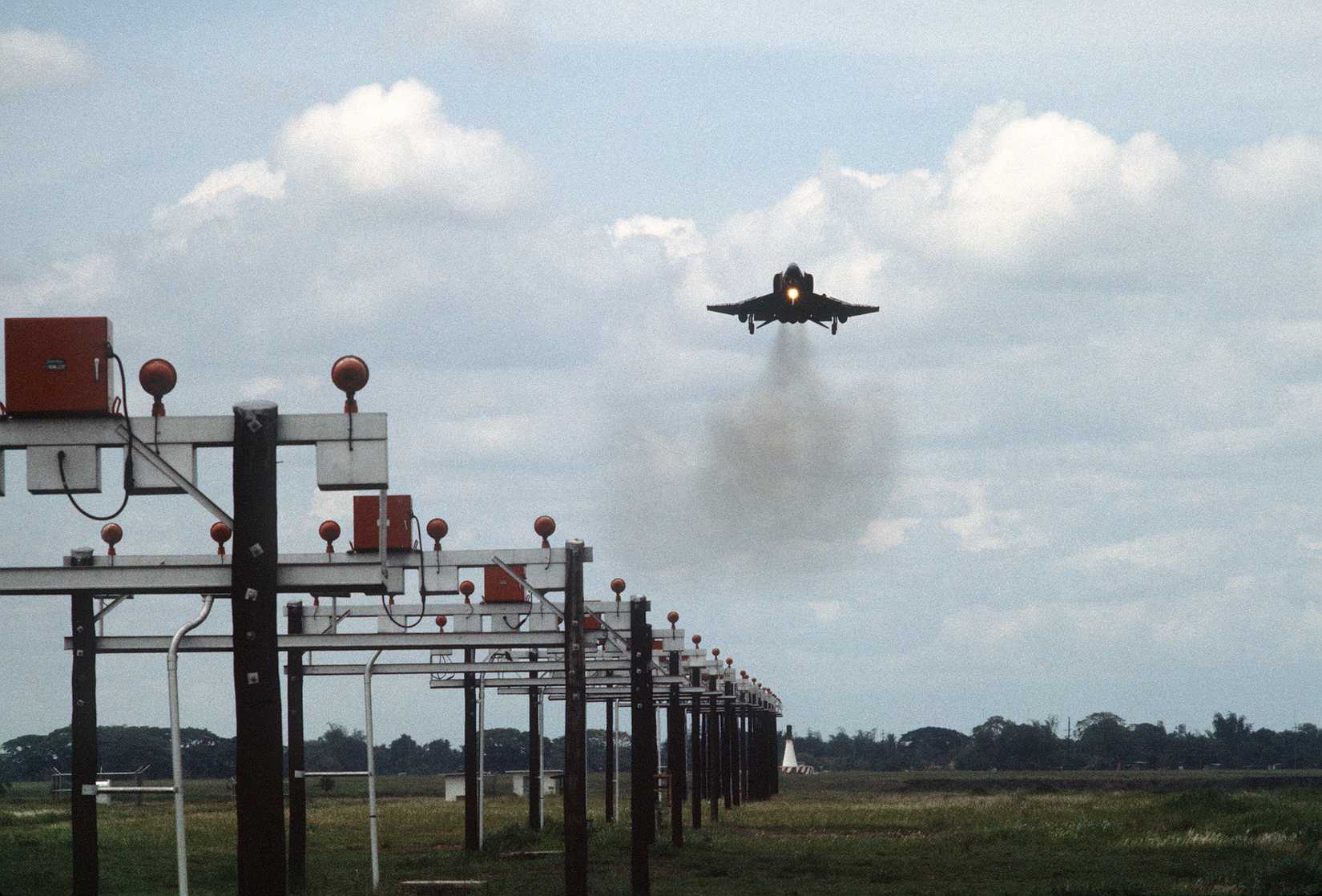 An F-4 Phantom II aircraft approaches the runway for a landing after a mission