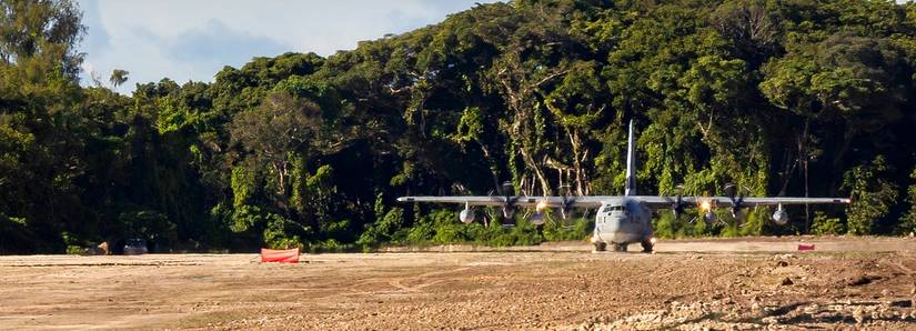 A C-130 is preparing to takeoff from an improvised airstrip on Peleliu Island. 