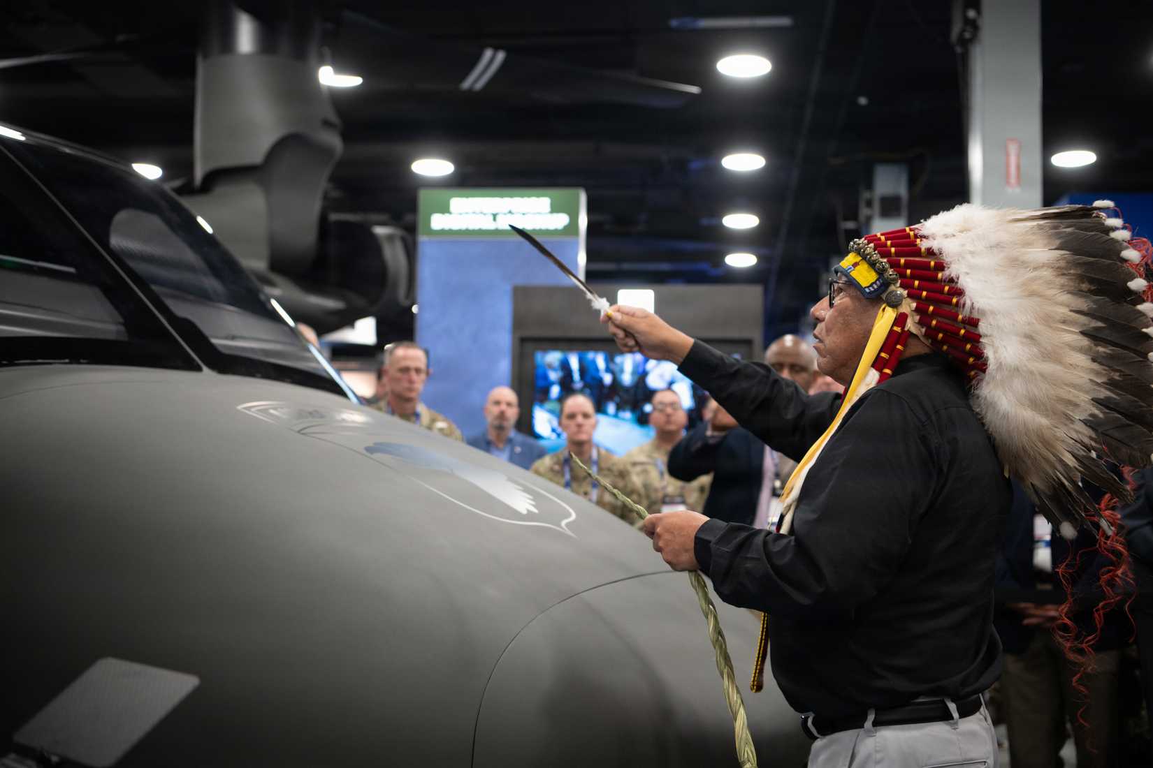 Chief Gordon Yellowman, Sr., a Cheyenne Tribal Historian, performs a traditional smudge during the Cheyenne Tribal visit to the MV-75 Cheyenne II Aircraft unveiling