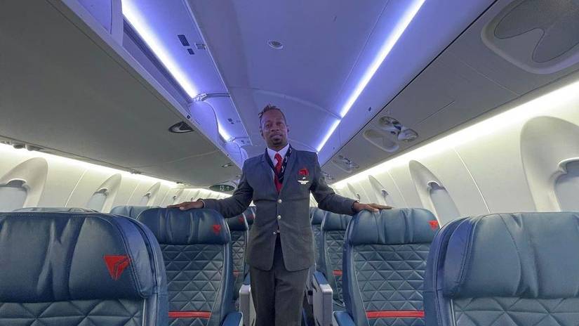 Delta Flight Attendant standing in empty cabin